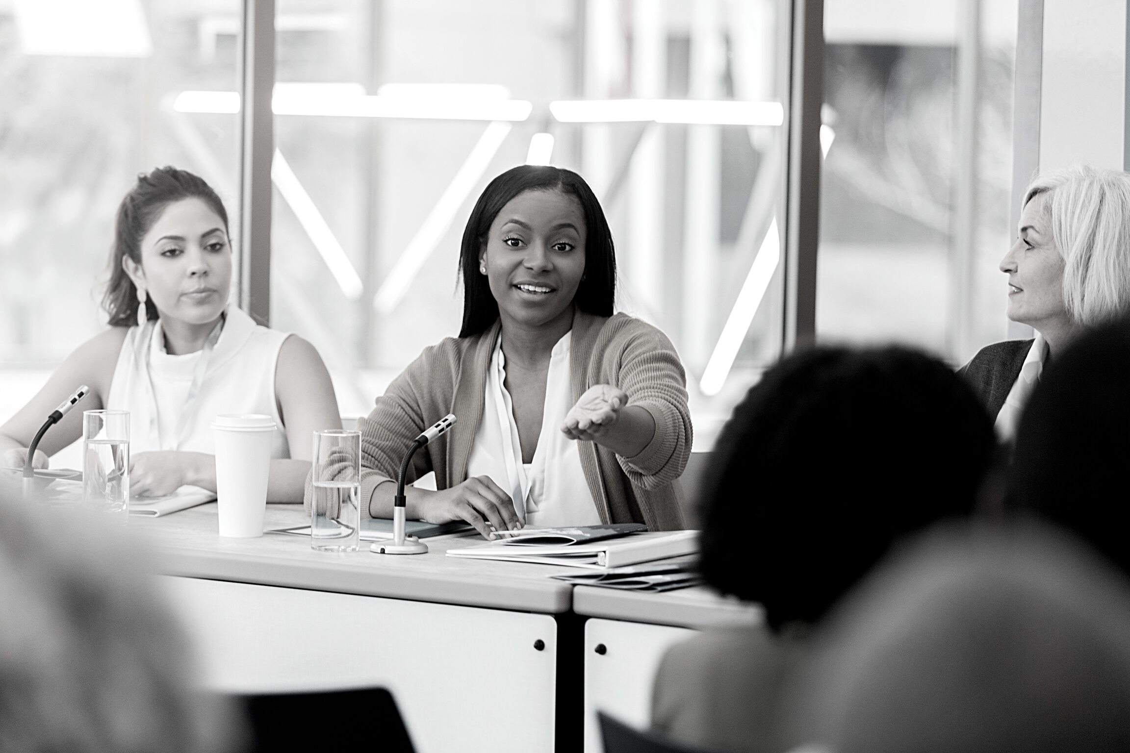 Businesswoman gestures during panel discussion